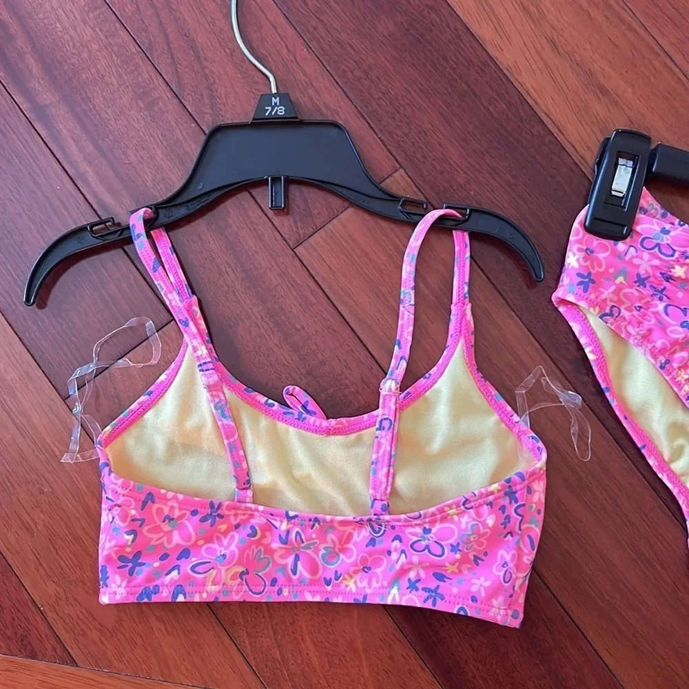 Girls set of swimsuits, pink set is a 7/8 and the one piece is a small.